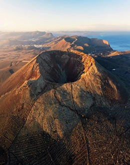 Las Palmas Prints: Aerial view of the crater of Volcan de la Corona in the during sunrise