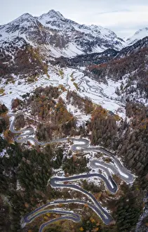 Mountain Pass Prints: Aerial view of curves of Maloja Pass road and Piz da la Margna in autumn