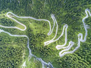 Aerial view of curves of the road between woods, Maloja Pass, Bregaglia Valley, canton