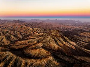 Horizon Over Water Prints: Aerial view of desert mountains and Atlantic Ocean at sunset from Sicasumbre viewpoint