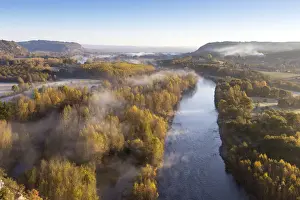 Aerial view of the Dordogne Valley & Dordogne river on a misty morning in autumn, Lot