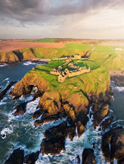 North Sea Prints: Aerial view of Dunnnottar Castle at sunrise