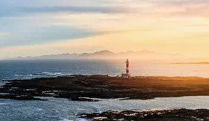 Horizon Over Water Prints: Aerial view of El Toston lighthouse in morning mist at dawn