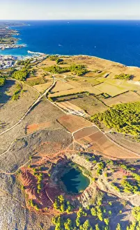 Mining Prints: Aerial view of emerald lake and bauxite quarry with crystal clear sea on background