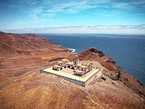 Red Rocks Prints: Aerial view of Entallada lighthouse on majestic cliffs overlooking the ocean