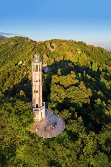Como District Prints: Aerial view of the Faro Voltiano (Volta Lighthouse) of Brunate overlooking Como and Como Lake in summer at sunset