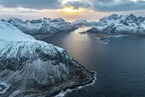 Road Trip Prints: Aerial view of the fishing village of Vareid and Flakstad beach covered with snow at dawn