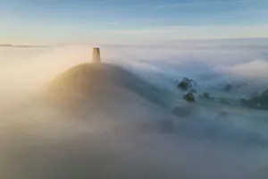 Somerset Prints: Aerial view of Glastonbury Tor shrouded in morning mist