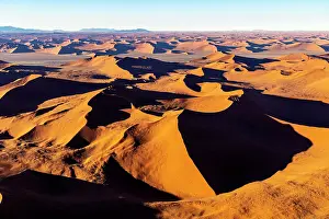 Dunes Prints: Aerial view of golden sand dunes at sunrise