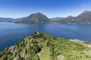 Aerial Photos Gallery: Aerial view of the green hill and castle overlooking Varenna surrounded by Lake Como