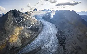 Wallis Prints: Aerial view of the Gries Glacier winding down from the Blinnenhorn mountain at sunset