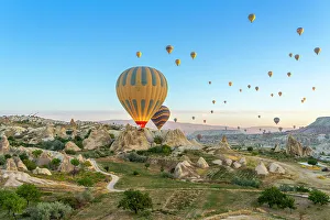 Kapadokya Prints: Aerial view of hot air balloon over rock formations at dawn