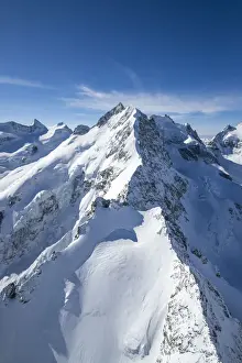 Canton Graubunden Prints: Aerial view of the long crest of ice and rock that takes to Bernina peak. Engadine