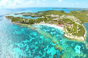 Leeward Islands Prints: Aerial view of a luxury resort on idyllic beach by coral reef