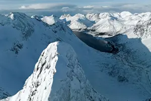 High Up Prints: Aerial view of majestic Litjemoa mountain peak covered with snow above a frozen fjord
