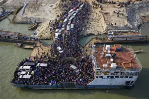 Aerial view of millions of people rush to board a ferry with their belongings to get home