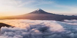 Drone Collection: Aerial view of Mt Fuji and sea of fog at sunrise, Yamanashi Prefecture, Japan