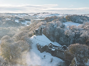 November Prints: Aerial view of Okehampton Castle in the snow, Devon, England. Autumn (November) 2024