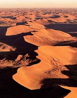 Sossusvlei Prints: Aerial view of orange sand dunes at sunrise