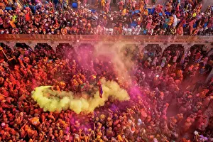 Aerial view of people celebrating the holy colour festival at Shri And Baba Temple, Nandgaon, Uttar Pradesh, India