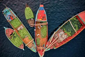 Aerial view of people working on commercial boats with fruits, Buriganga river, Keraniganj, Dhaka, Bangladesh