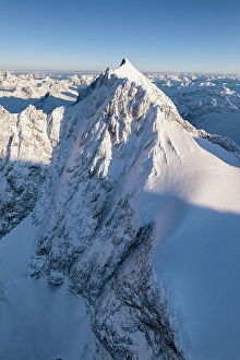 Mountain Peak Prints: Aerial view of Piz Bernina after snowfall during sunrise