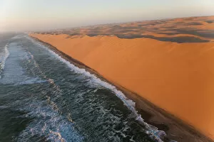 Namib Desert Gallery: Aerial view over sand dunes & sea, Namib Desert, Namibia