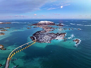 Drone Collection: Aerial view of a scenic bridge crossing the frozen arctic sea at dusk, Sommaroy, Troms county