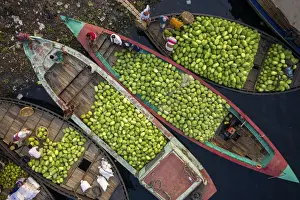 Retail Prints: Aerial view of several small commercial boats with people unloading watermelons at Old
