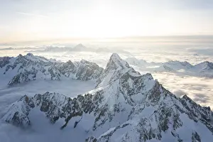 Summit Prints: Aerial view of snowy peaks of Mont Blanc and Dent du Geant during sunrise, Courmayeur