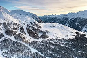 Ski Resort Prints: Aerial view of snowy ski slopes surrounded by frozen woods