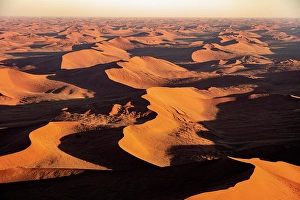 Sossusvlei Prints: Aerial view of sprawling orange sand dunes at sunrise