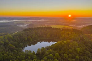 Aerial view on the sunrise above Windsborn volcanic crater lake, Eifel