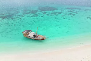 Equatorial Collection: aerial view taken by the drone of the tourist boat, anchored near a tongue of sand, Zanzibar