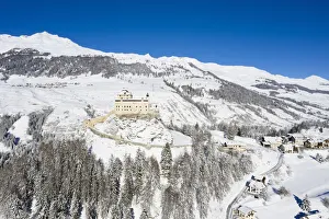 Aerial view of Tarasp castle after snowfall. Tarasp, Lower Engadine, Canton of Grisons