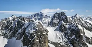 Aerial view of Torrone Peak in winter with Bernina Peak in the background. Valmasino