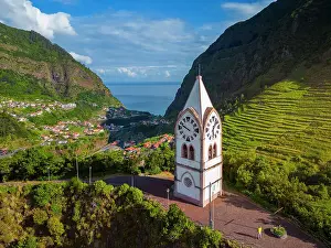Atlantic Island Prints: Aerial view of a tourist at Capelinha de Nossa Senhora de Fatima surrounded by terraced fields at sunrise