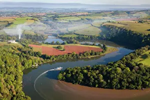 2023 Prints: Aerial view of a tourist riverboat cruising up the meandering River Dart towards Totnes
