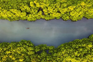 Aerial view of a traditional boat sailing through the bay