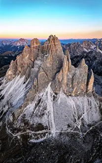 Bolzano Prints: Aerial view of Tre Cime di Lavaredo rocky peaks at dawn in autumn