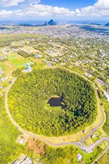 Aerial view of Trou Aux cerfs volcano crater with Curepipe city, Rempart mountain