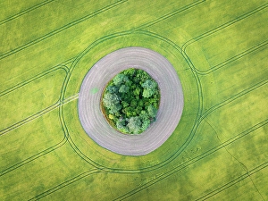 West Sussex Prints: Aerial view of a tumulus in a crop field, West Sussex, England. Summer (July) 2024