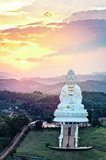 Romantic Sky Prints: Aerial view of Wat Huay Pla Kang temple on top of lush green hills in sunset mist