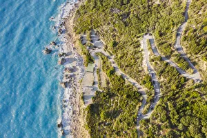 Aerial view of the winding road to Megali Petra beach. Lefkada, Ionian Islands region