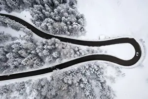 Curves Prints: Aerial view of the winding road of the Presolana Pass after a winter snowfall