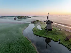 Moody Light Prints: An aerial view of windmills in the mist at dawn, North Holland, Netherlands
