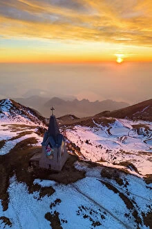 Mountainscape Collection: Aerial view of a winter sunset over Monumento al Redentore chapel on the top of Mount Mount