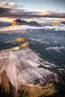 Environment Prints: Aerial view of woods of Val Gardena with Sassolungo and Seceda emerging from autumn mist