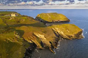 Aerial vista of Tintagel Castle and nearby Cornish coastline at dawn, Cornwall, England