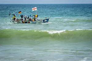 Africa, Benin, Grand Popo. A colorful fishing boat coming back home